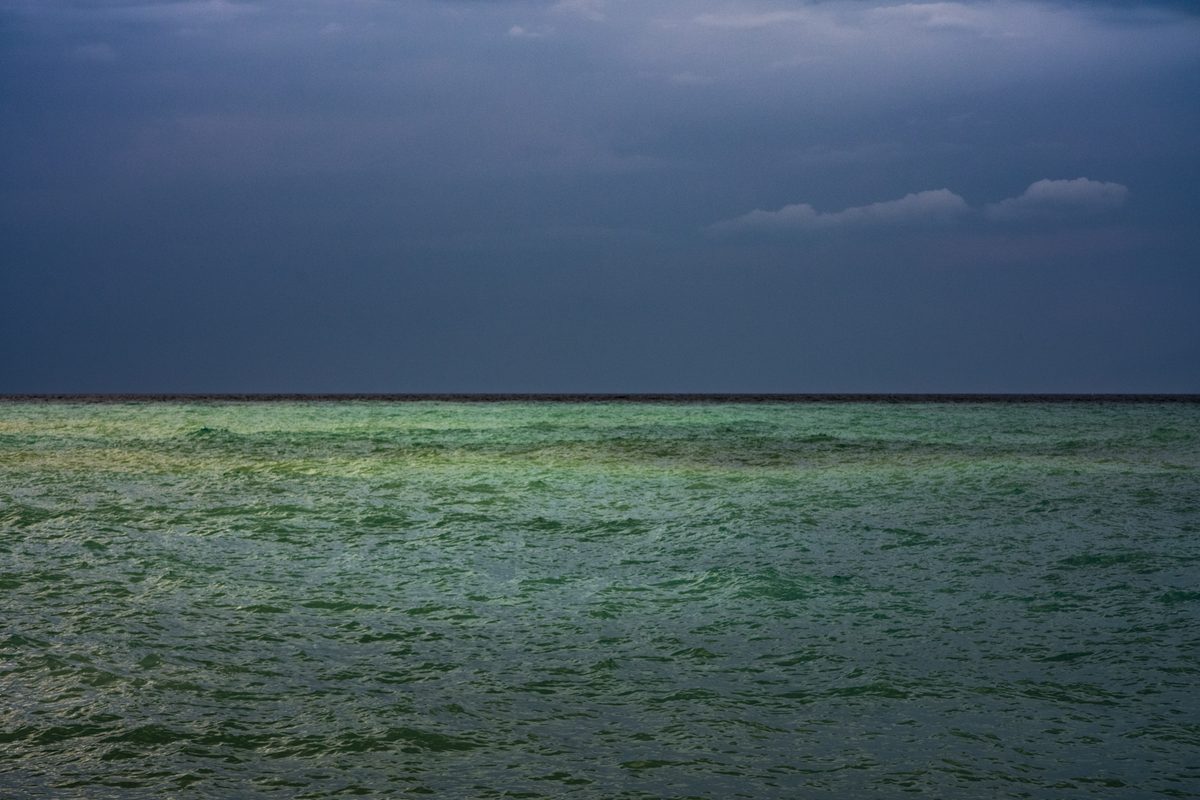 Colour editing: green sea under a grey sky